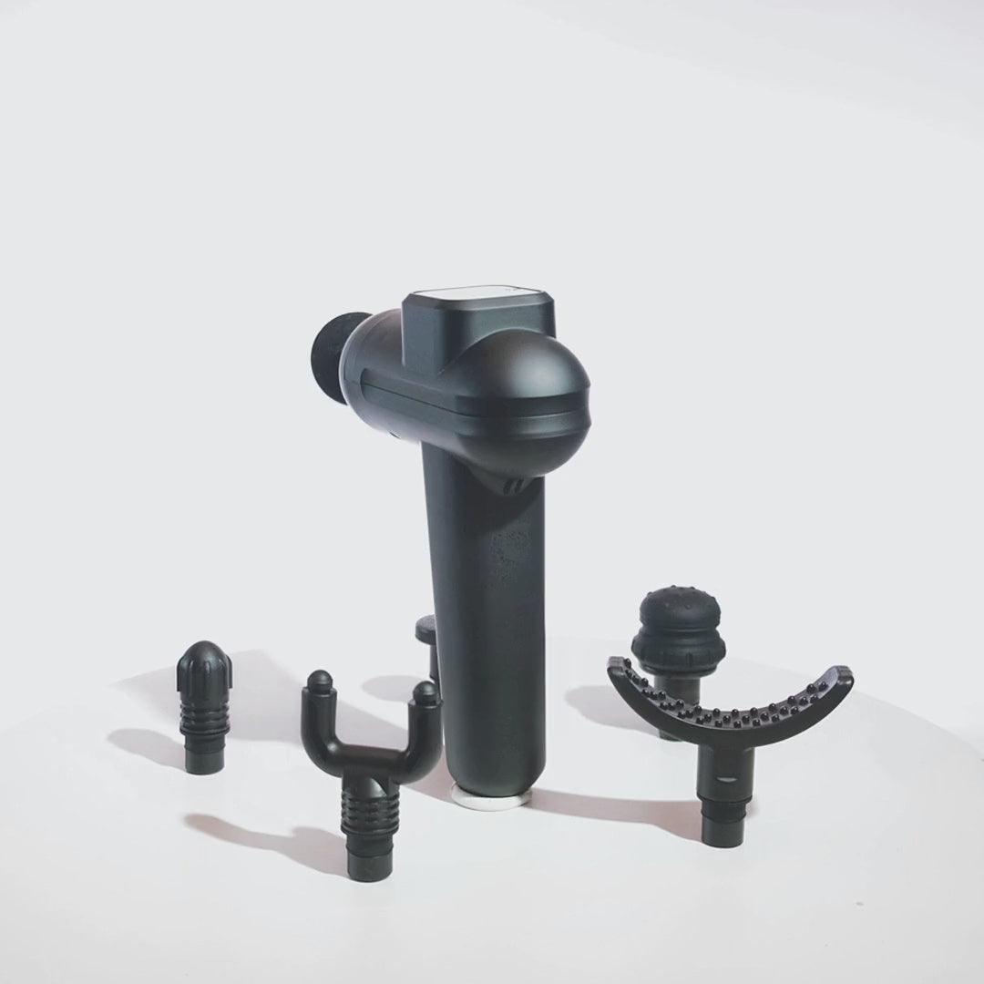 Black 20 Speed Pulse and Cotton massage gun rotating 360 degrees, shown with its 6 interchangeable heads